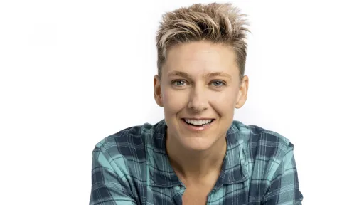 Woman with short blonde hair waring a plaid shirt